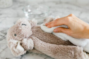 A child holding a clean plush teddy bear